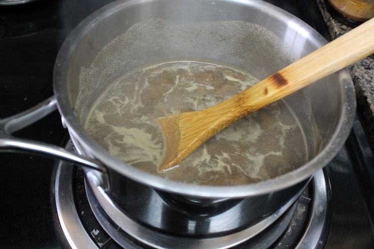 stainless steel pot on the stove with essiac tea mixture simmering