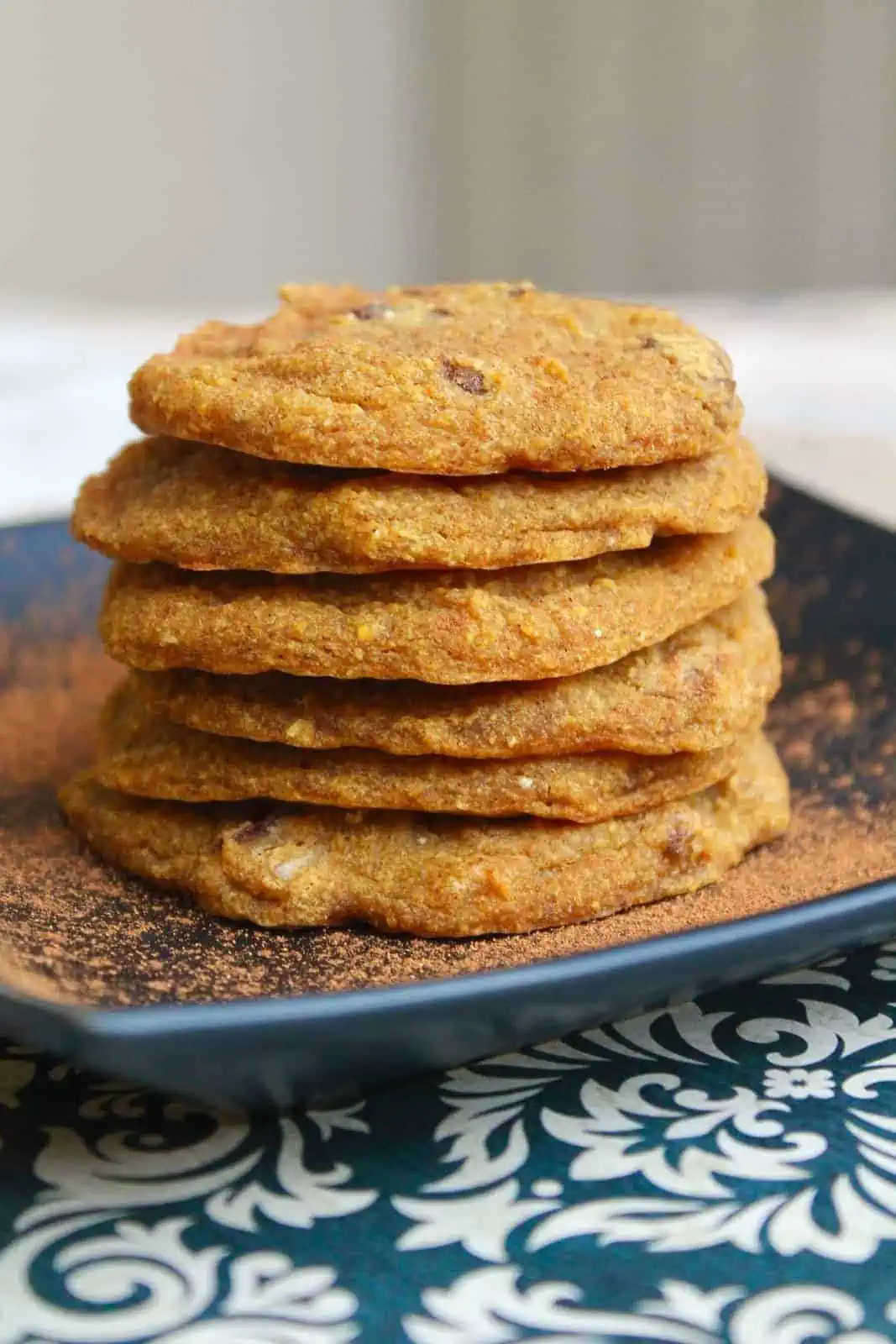 A close up of pumpkin cookies stacked on top of each other