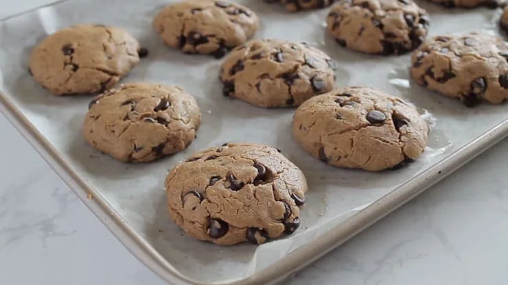 Side view of keto chocolate chip cookies on baking sheet