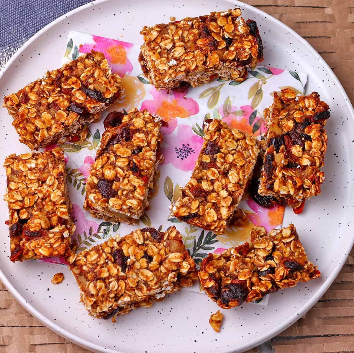 overhead shot with a floral white plate with baked sugar free granola bars on it