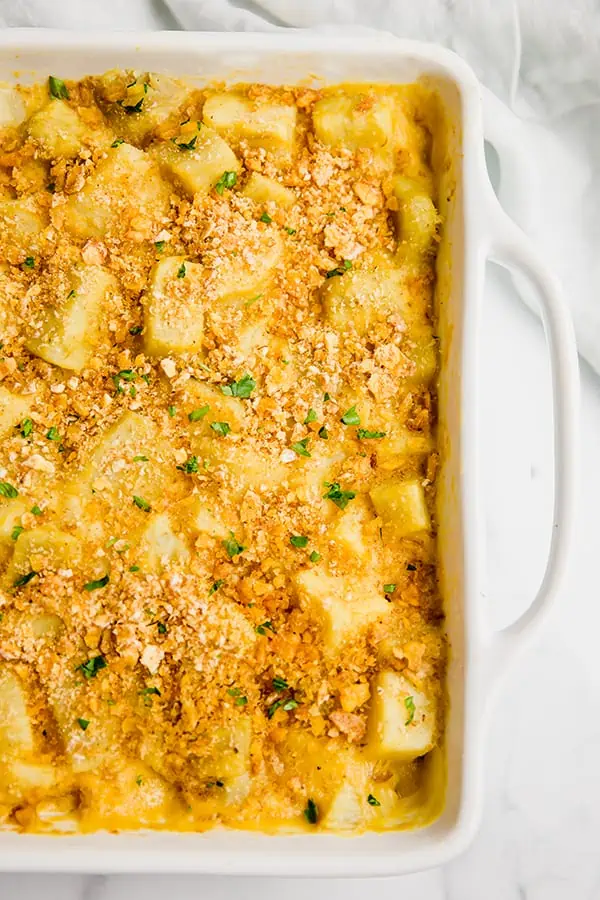 overhead shot of autoimmune paleo cheesy sweet potato casserole in white casserole dish