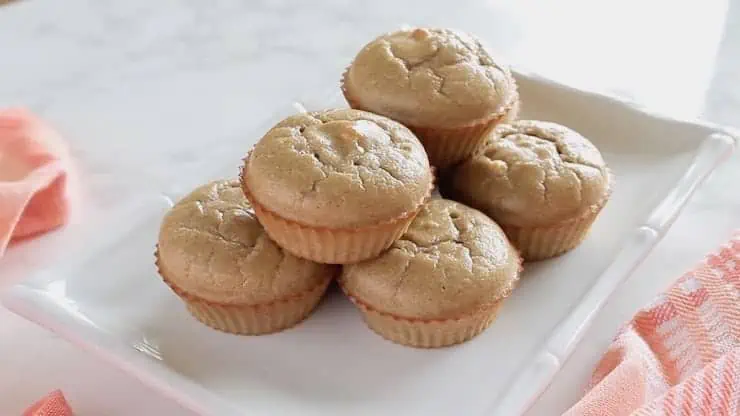 six applesauce muffins on a white plate