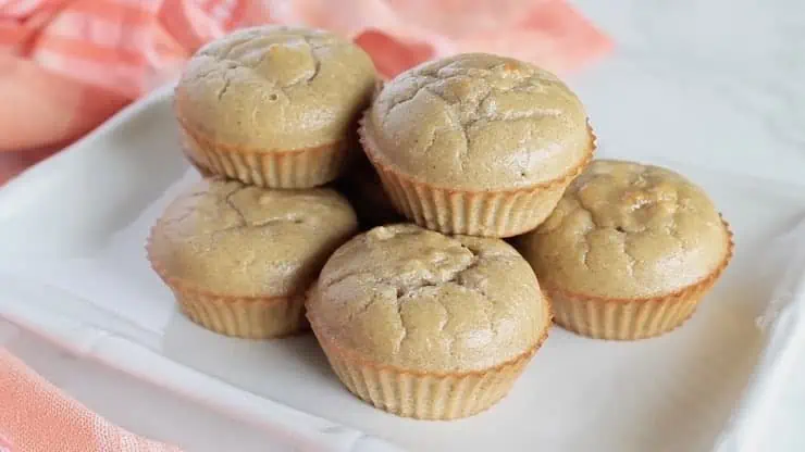 six applesauce muffins on a white plate