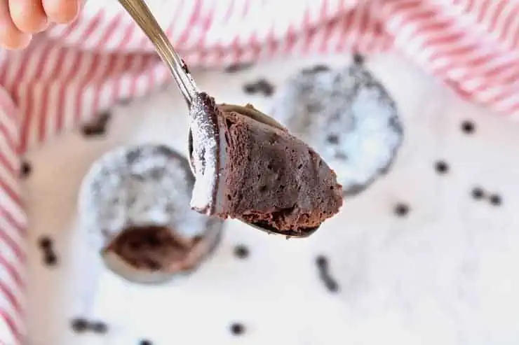 Close up of a spoon with a piece of chocolate keto mug cake on it