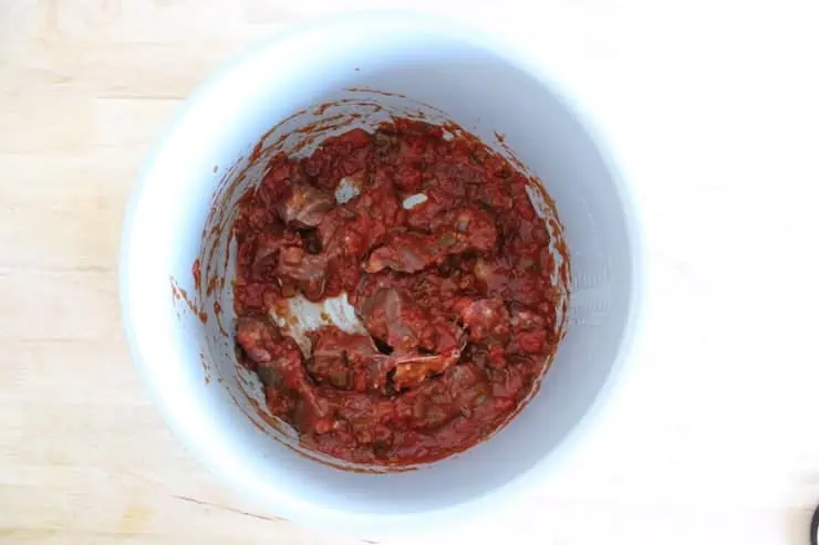 Uncooked beef stew meat and salsa mixture in the instant pot