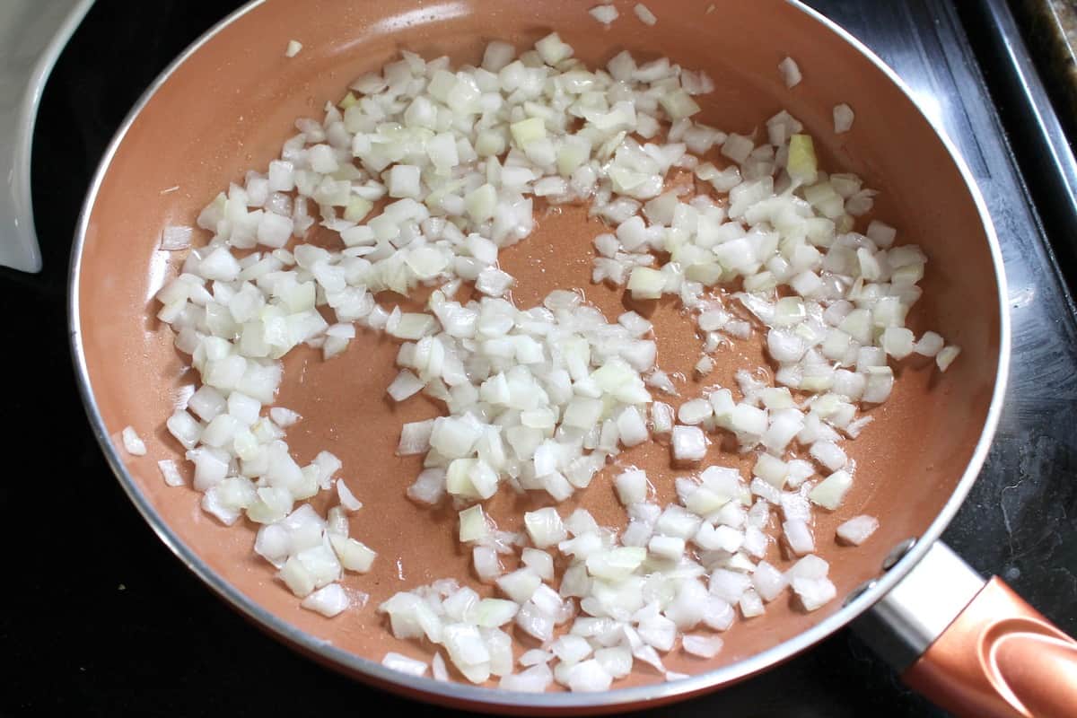 Chopped onion cooking in a pan on the stove