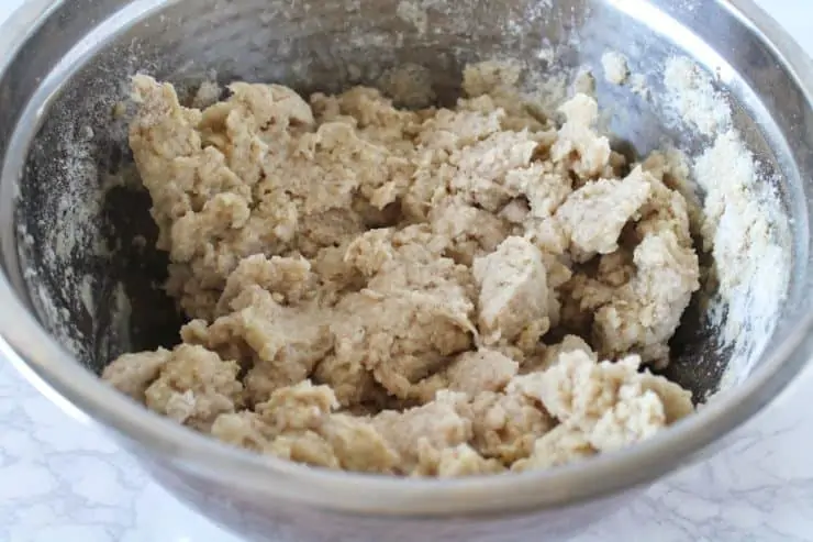 Close up of bread dough in a metal mixing bowl