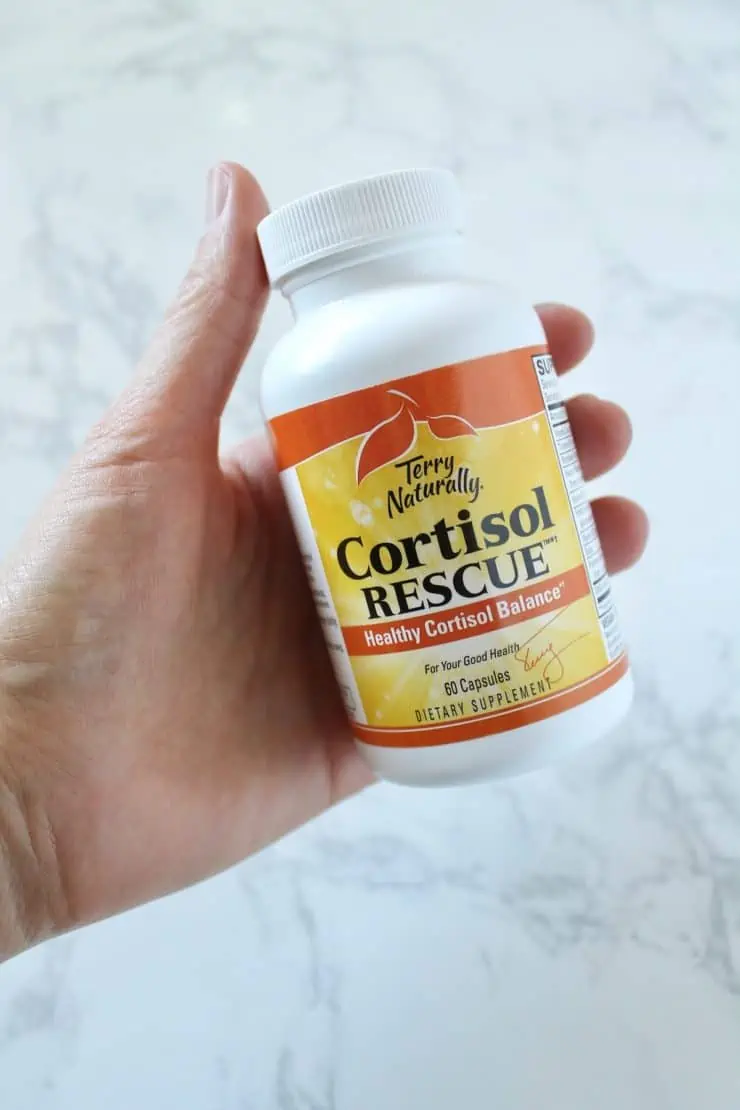 Hand holding a bottle of cortisol rescue vitamins