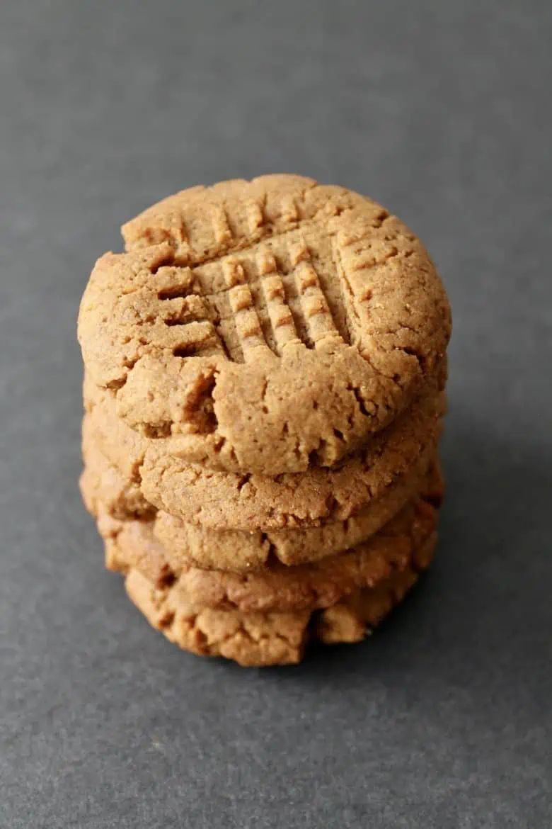stack of five gluten free peanut butter cookies on a grey surface