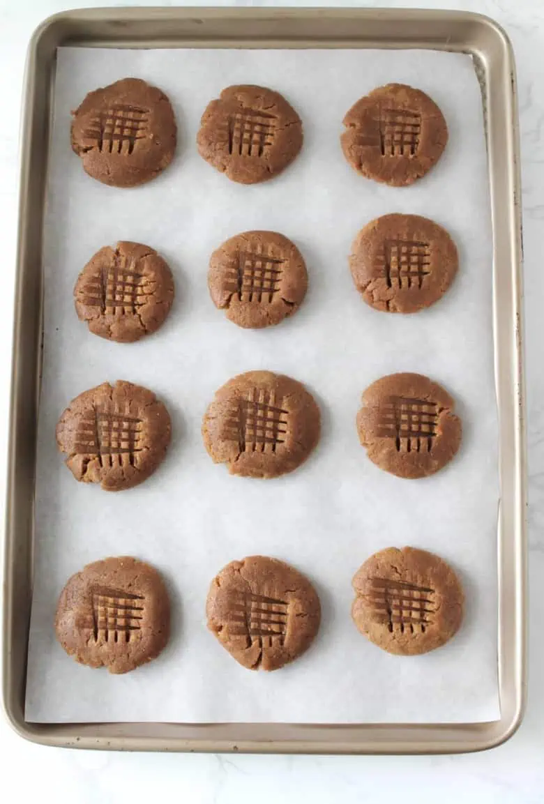 overhead shot of uncooked gluten free peanut butter cookies on baking sheet