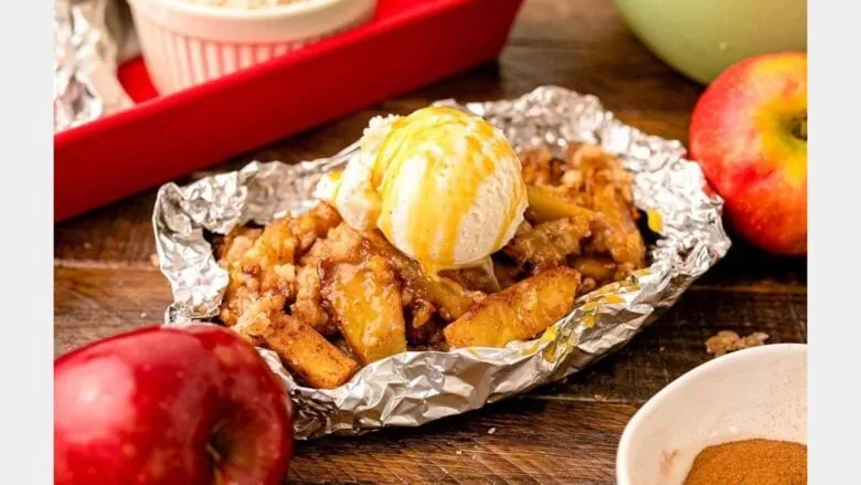 foil packet filled with apple crisp topped with ice cream