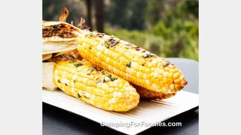 3 ears of cooked corn on the cob on a white plate