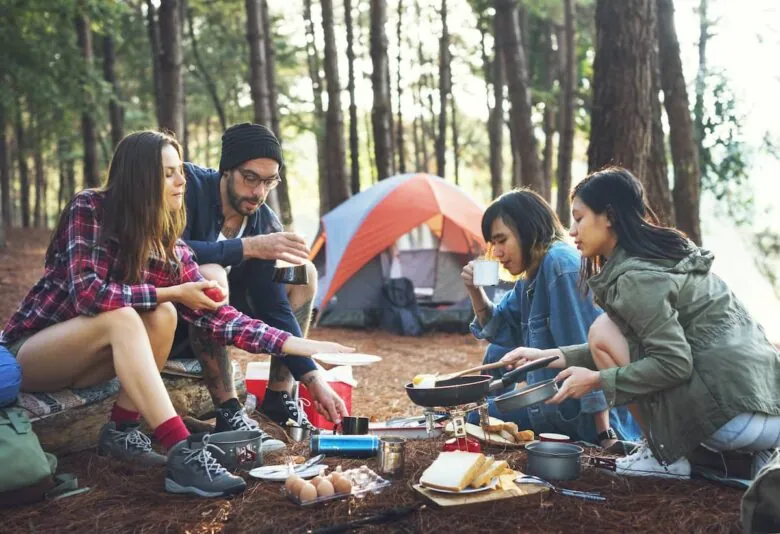 Family gathered around a meal at a campground