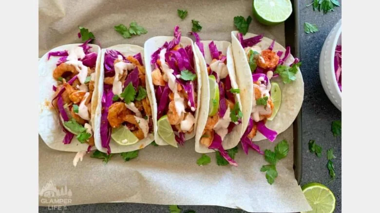 shrimp tacos topped with purple cabbage