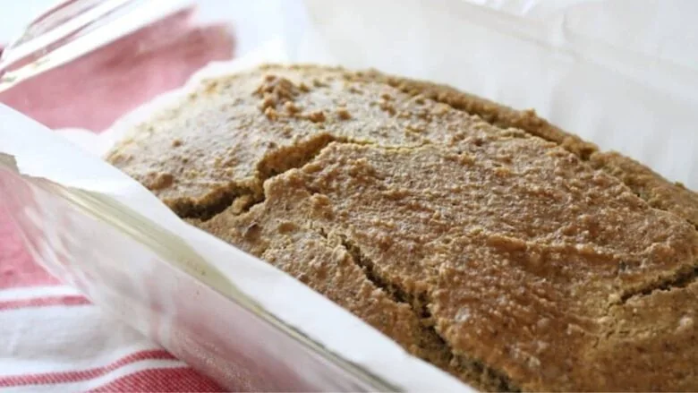 close up of baked grain free bread in a loaf pan