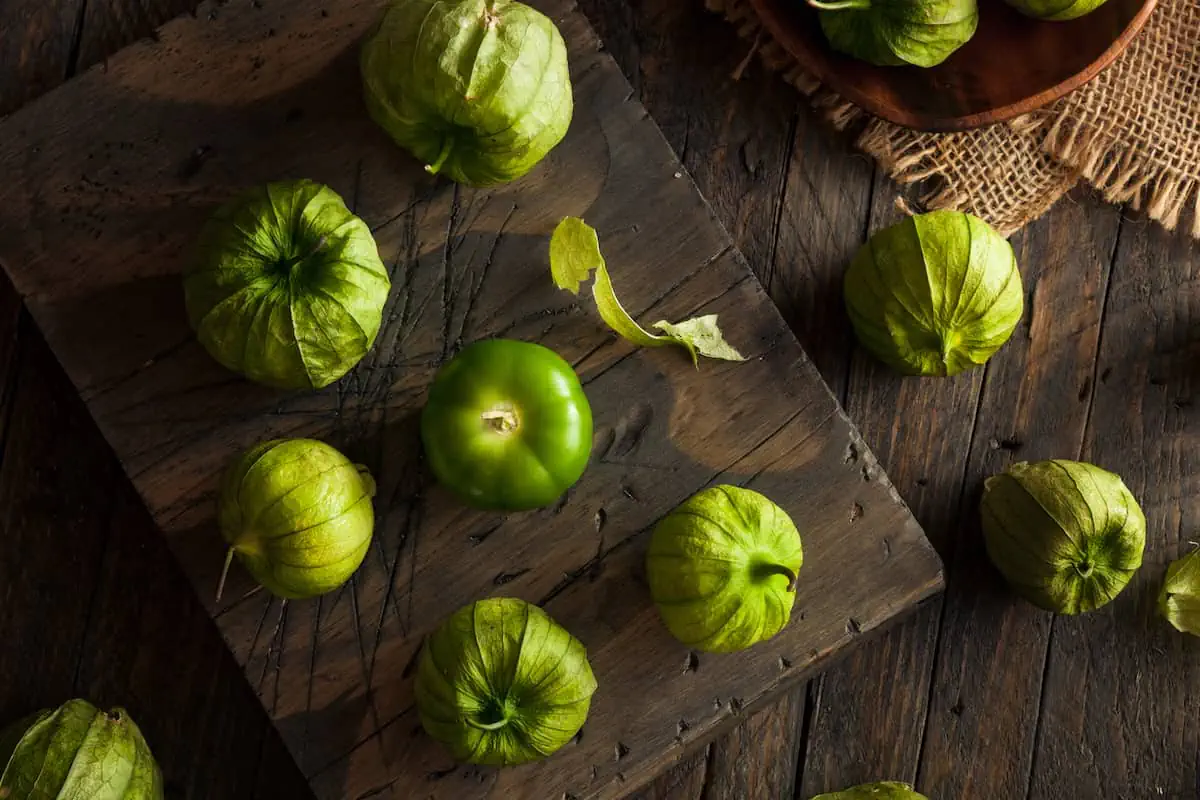 Overheat shot of several tomatillos on a cutting board