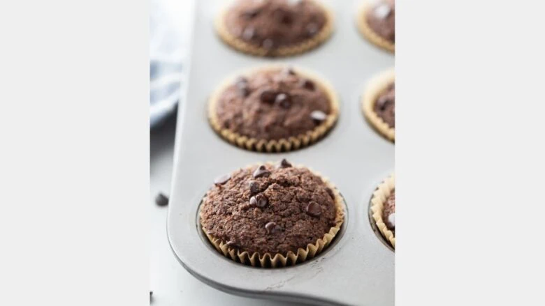 Chocolate chip muffins in a muffin tin.