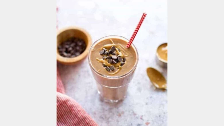 A chocolate smoothie with chocolate chips.