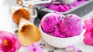 Purple ice cream in a bowl with few ingredients.