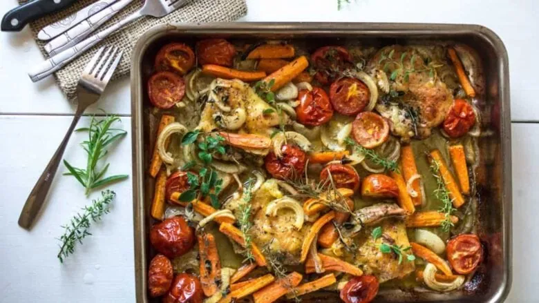 Roasted chicken and vegetables in a baking dish.