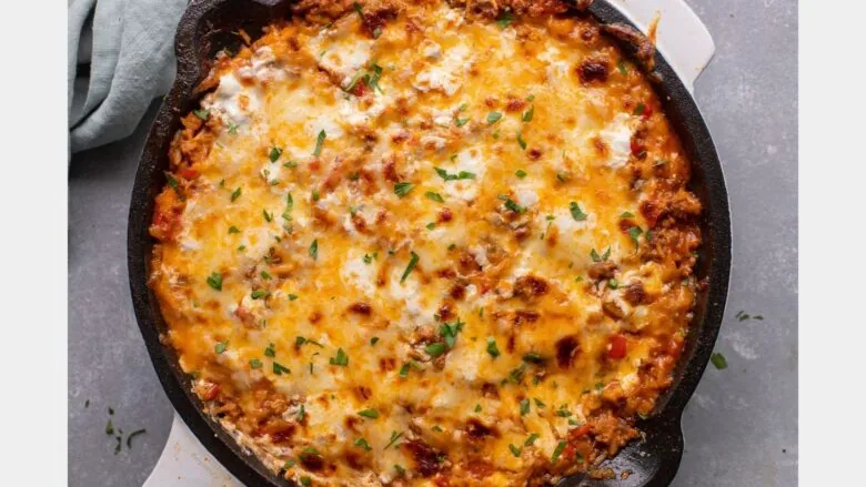 A skillet filled with cheesy casserole.