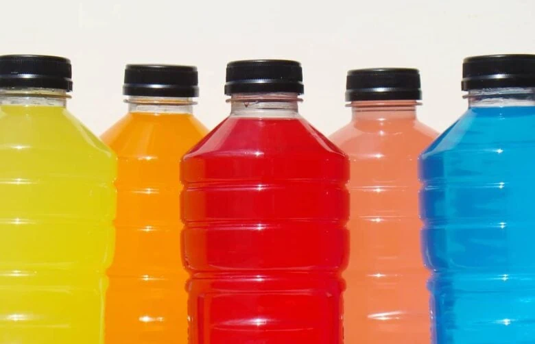 A group of unhealthy sports drink bottles on a white background.