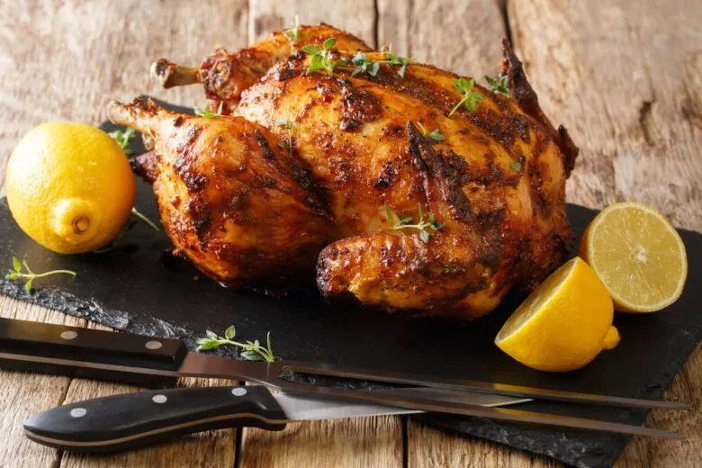 Rotisserie chicken with fresh herbs and lemon.