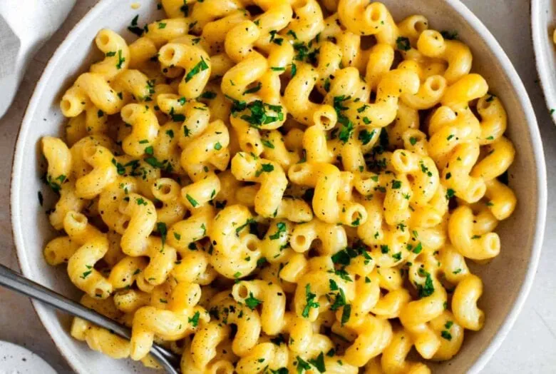 Macaroni and cheese in a white bowl.