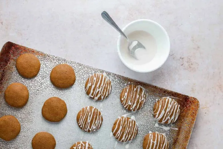 Gingerbread cookies on a baking sheet with icing.