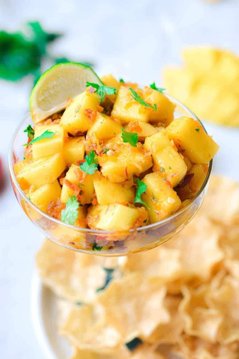 Fresh mango habanero salsa in a glass bowl with tortilla chips.