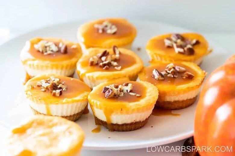 Pumpkin cheesecake bites on a white plate.