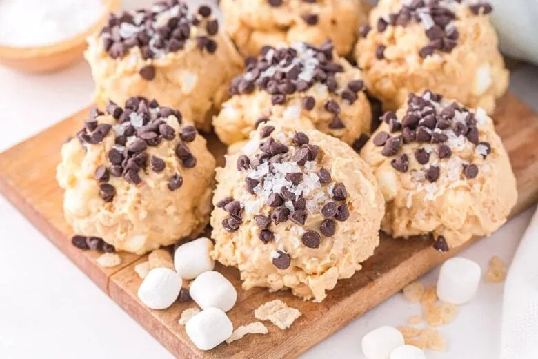 Peanut butter chocolate chip cookies on a cutting board.