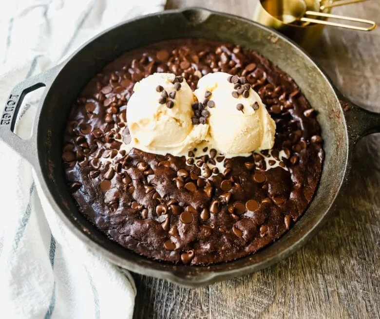A skillet filled with chocolate cake and ice cream.