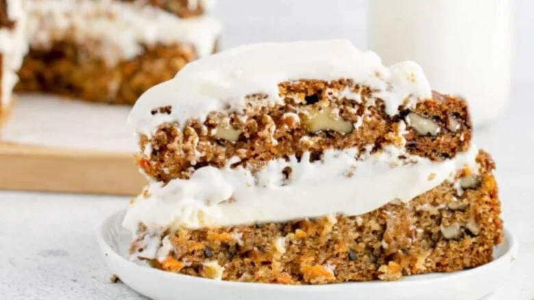 A slice of carrot cake on a white plate.