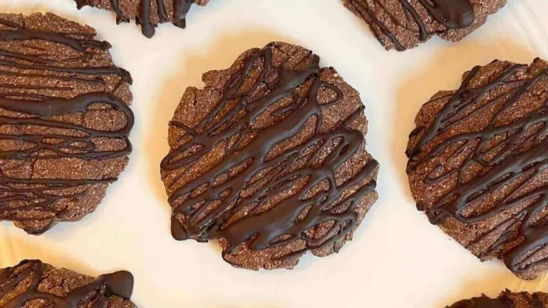 Chocolate dipped cookies on a white plate.