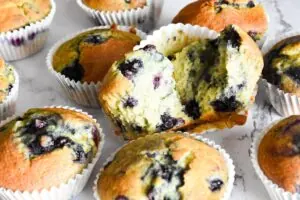 Blueberry muffins with a bite taken out of them are made using a delightful blueberry muffin cake mix recipe.