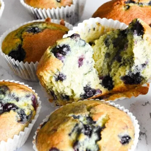 Blueberry muffins with a bite taken out of them are made using a delightful blueberry muffin cake mix recipe.