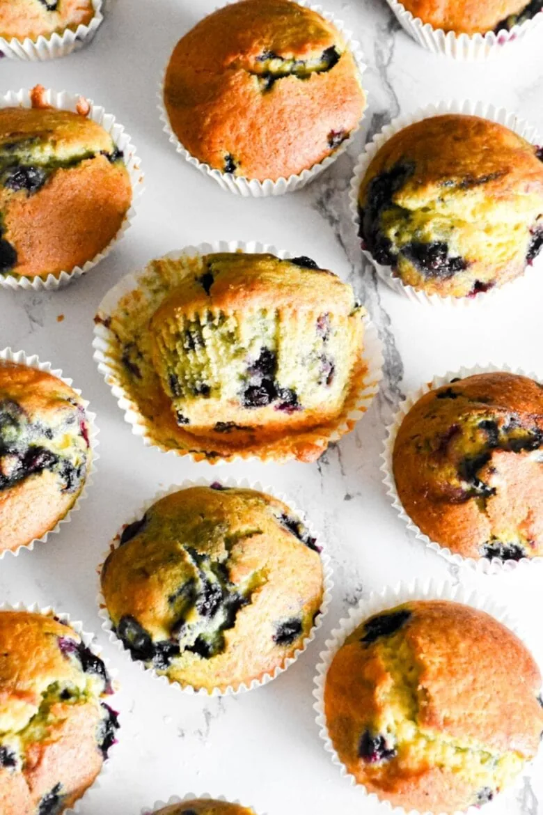 Blueberry muffins with a bite taken out of them made from a delicious blueberry muffin cake mix recipe.